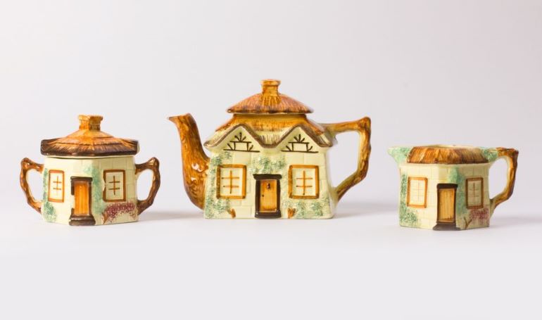 Three teapots from the MERL collection, modeled after cottages