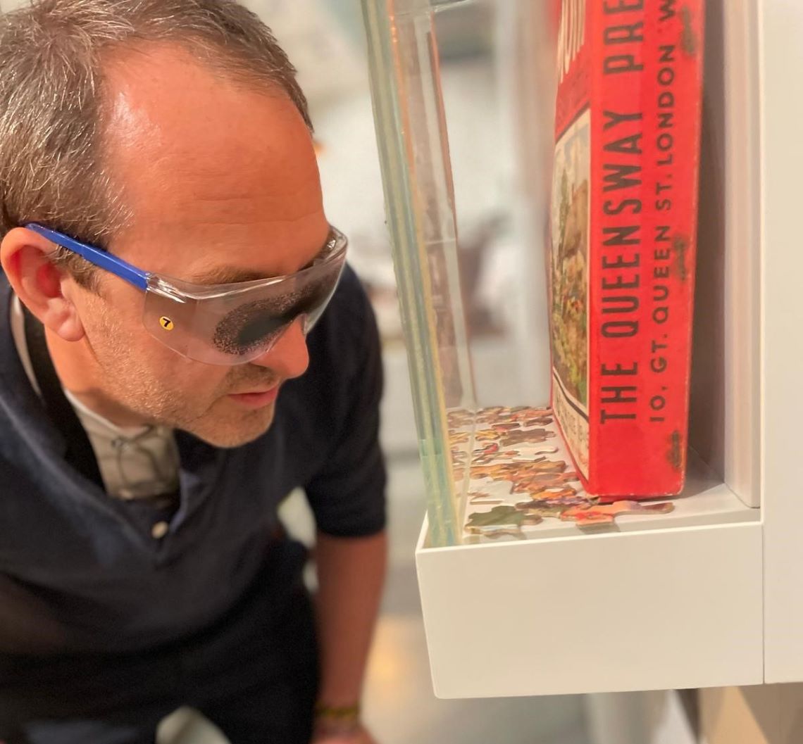 Ollie Douglas, MERL curator, leaning close to an exhibit