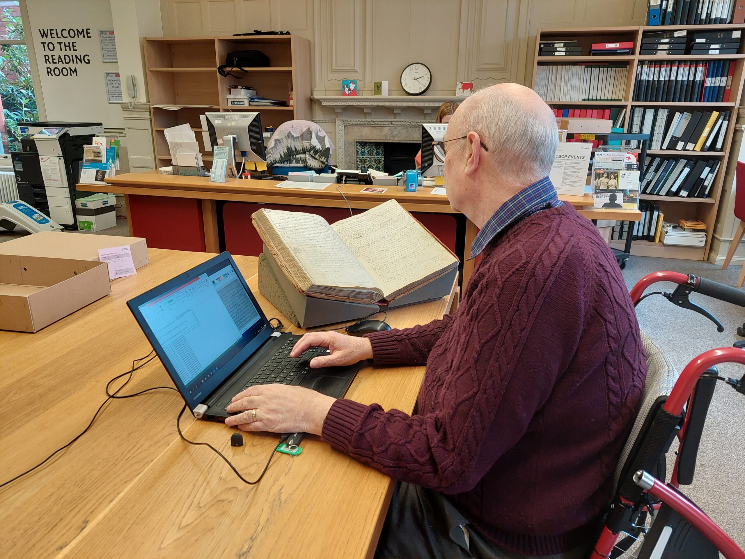 A person in a wheelchair, accessing an archive.