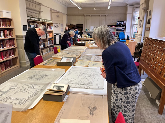 People look at plans on a table in The MERL reading room