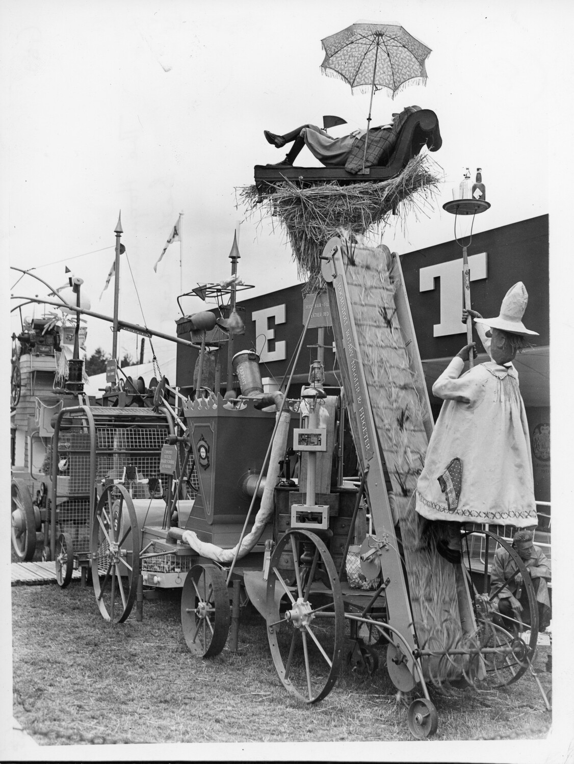 A machine showing a farmer reclining on a feather bed.