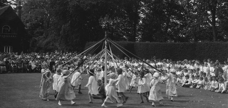 May Day pageant involving school children, dancing around the maypole
